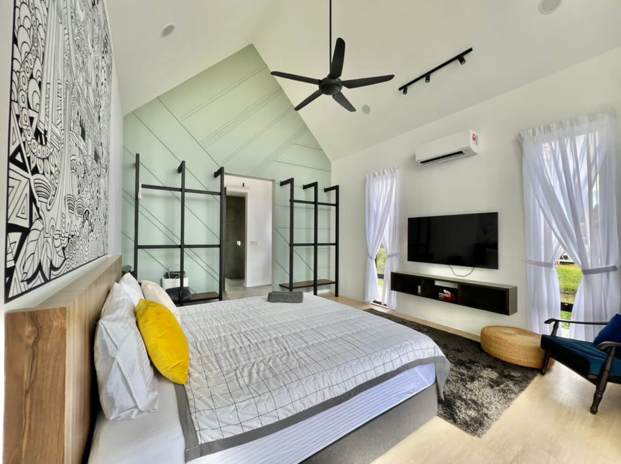 ASTA Suite at Ezu Isle Langkawi villa with pool: king bed under a high A-frame ceiling, mural, smart TV and armchair