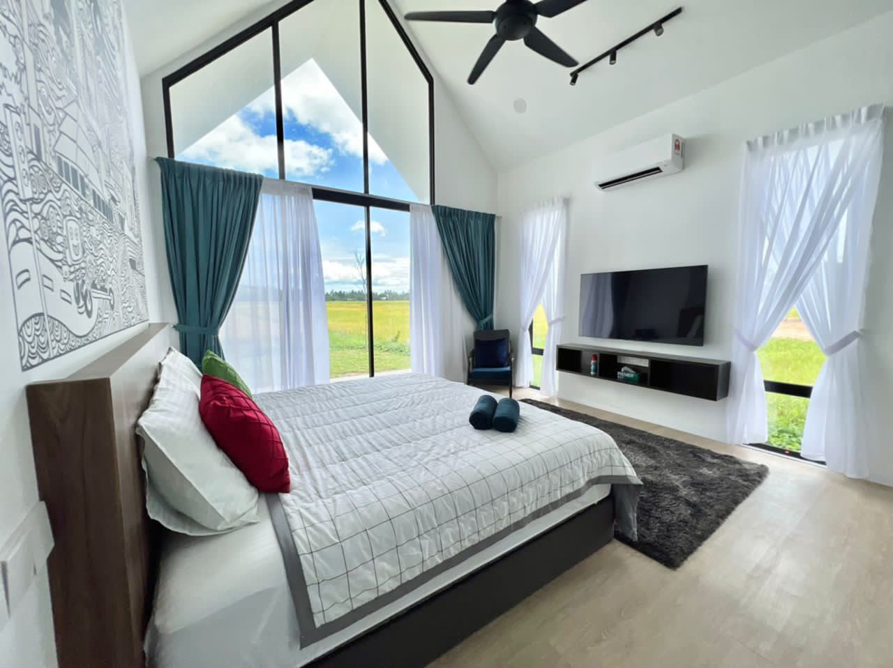 CYBER Suite at Ezu Isle Langkawi villa: king bed, smart TV and teal-curtained glass gable framing the padi fields