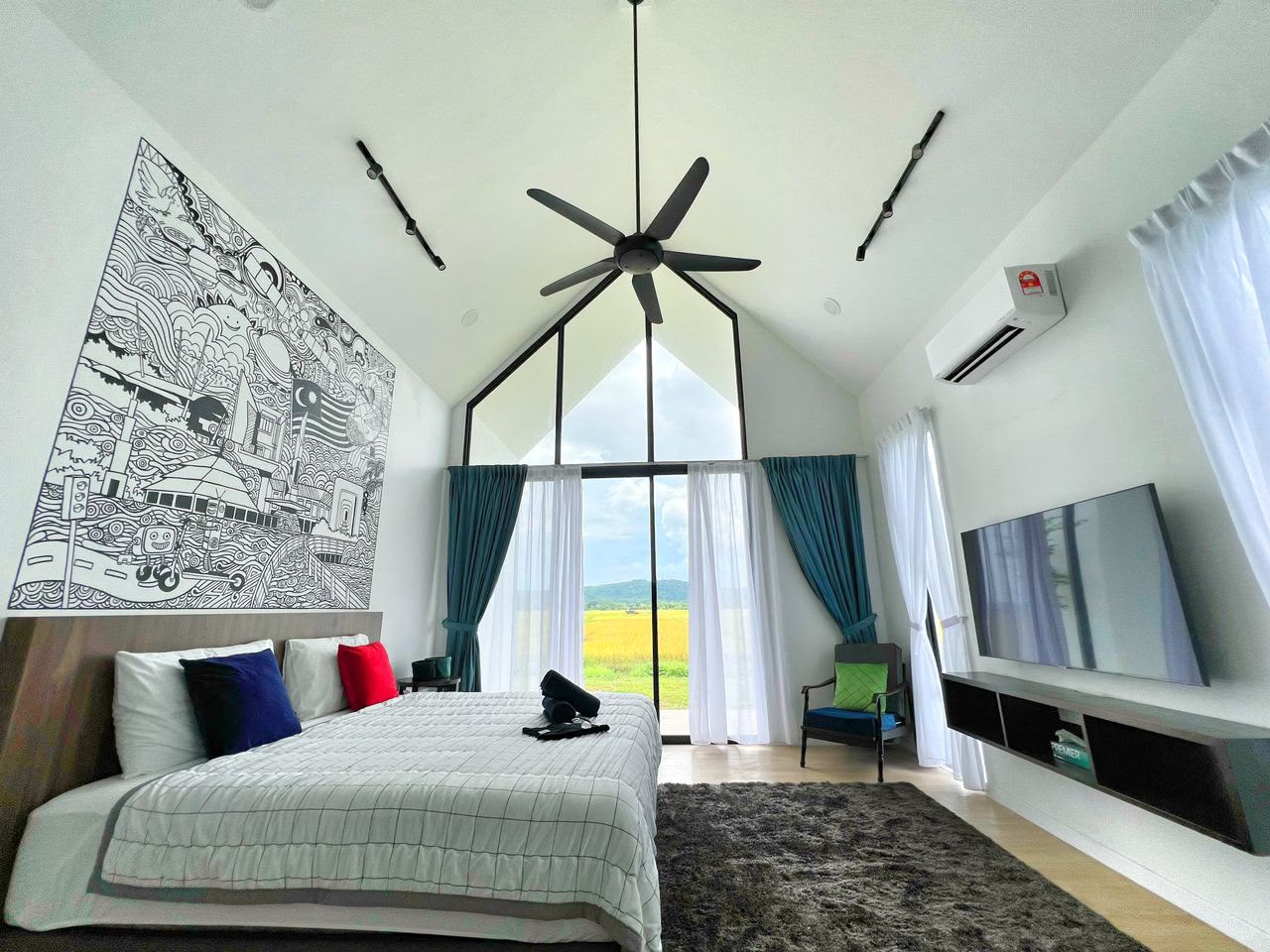CYBER Suite at Ezu Isle Langkawi villa with pool: king bed, Malaysian mural and A-frame glass window framing the padi fields and hills