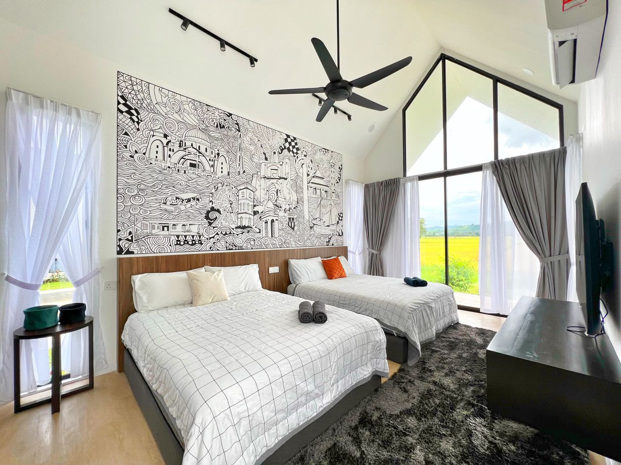MYA Suite at Ezu Isle Langkawi villa with pool: two queen beds, hand-drawn landmark mural, smart TV and glass gable facing the padi fields and hills